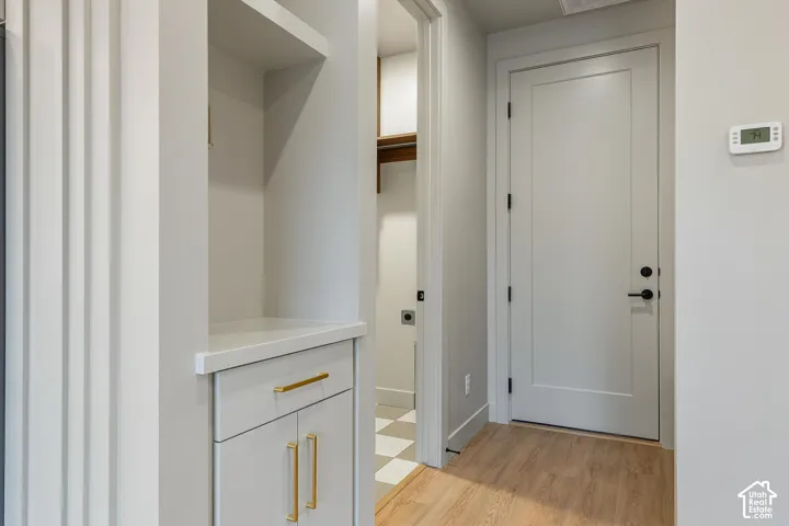 Built-in cabinetry with gold-finish hardware and a light countertop