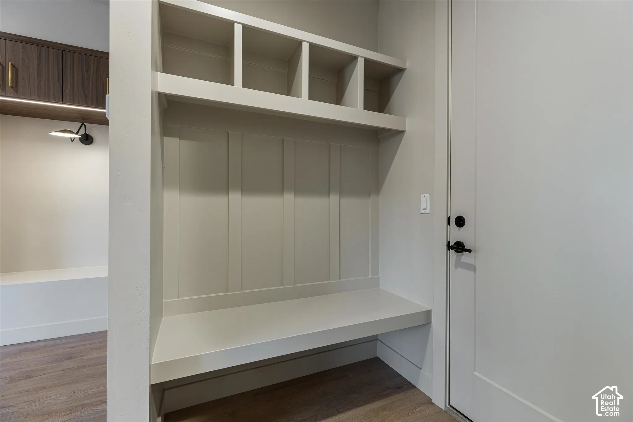 Built-in mudroom bench with cubby storage and beadboard paneling