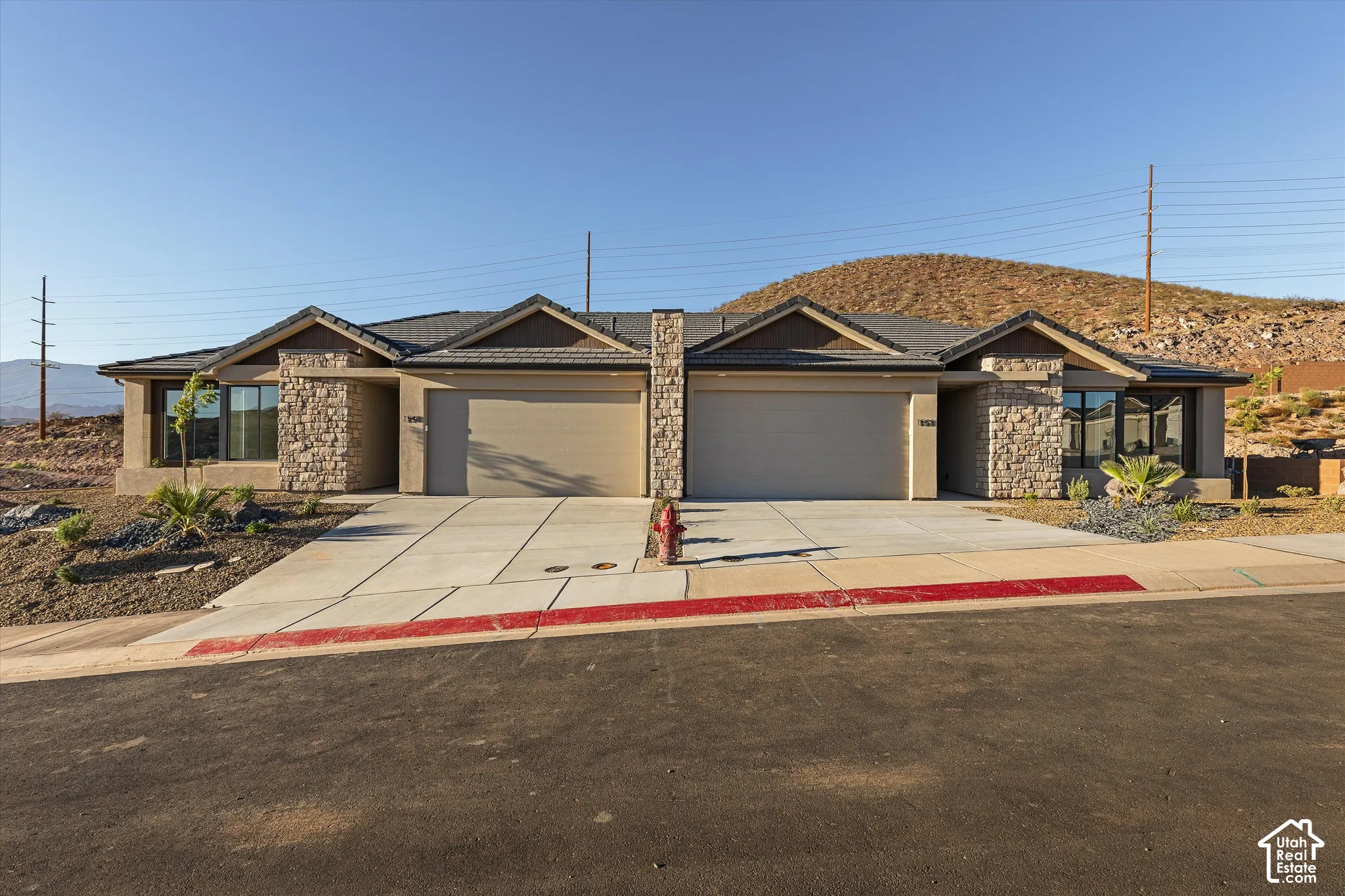 Stone veneer and stucco exterior with dark trim accents