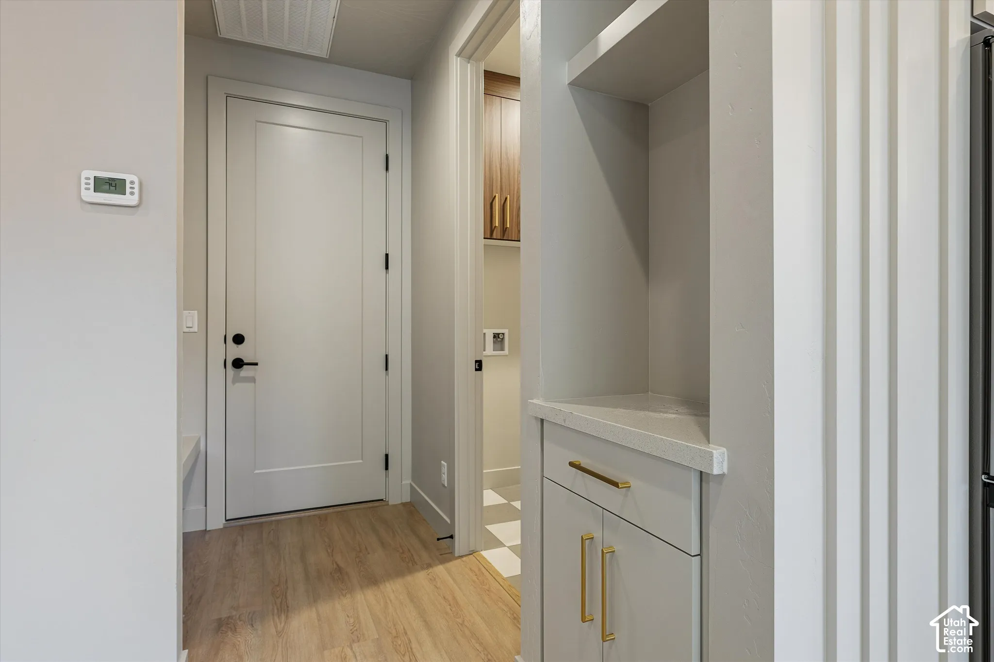 Light wood-finish flooring with a neutral wall color