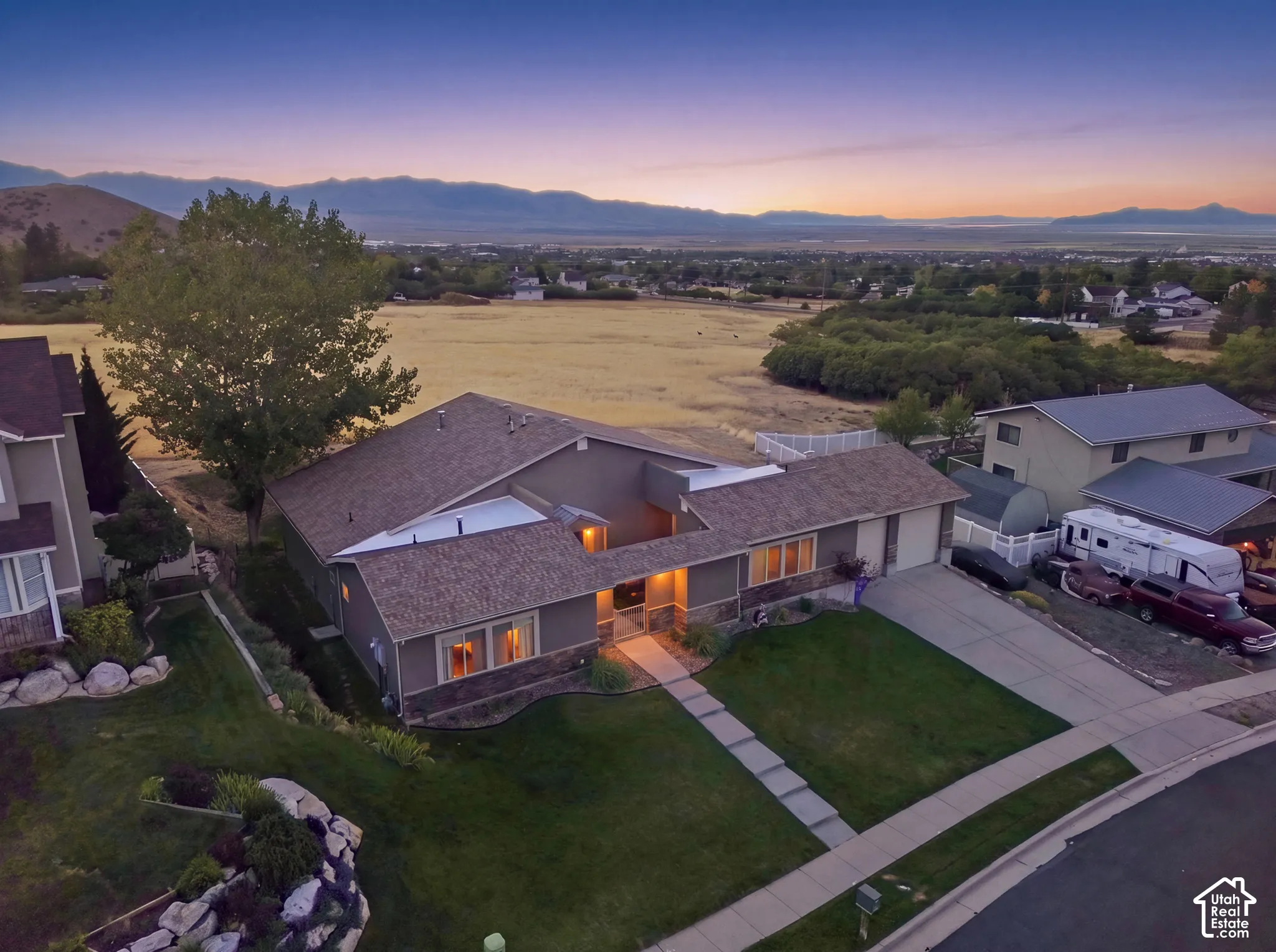 Single-story exterior with stone and siding accents, an attached garage, and a concrete driveway