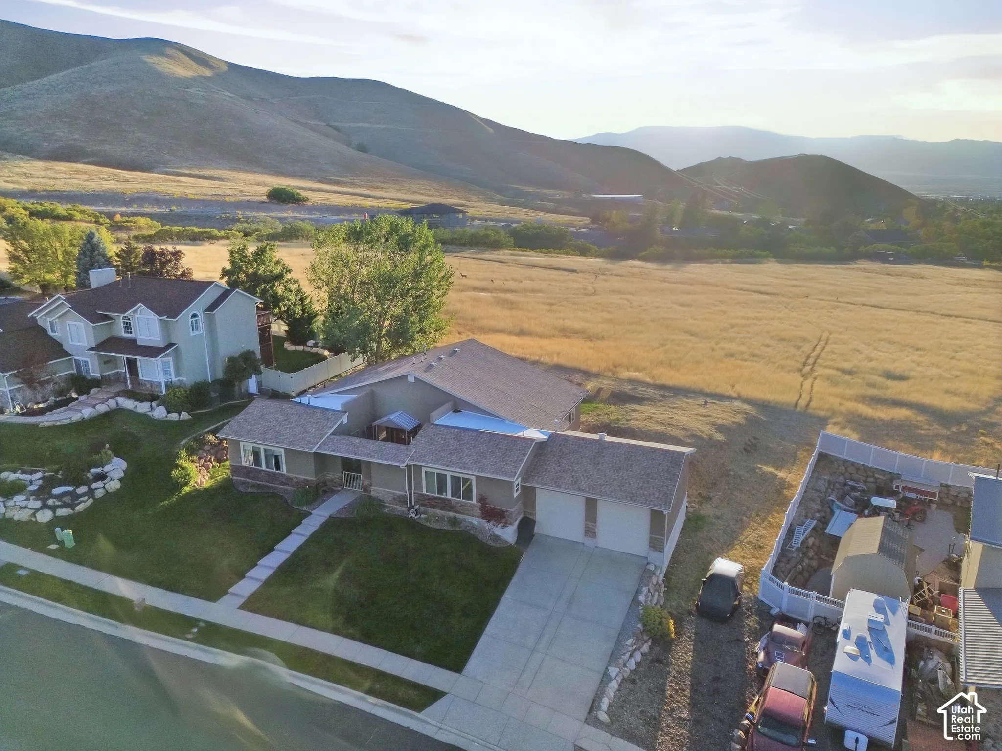 Expansive property with a paved driveway, attached two-car garage, and a manicured front lawn