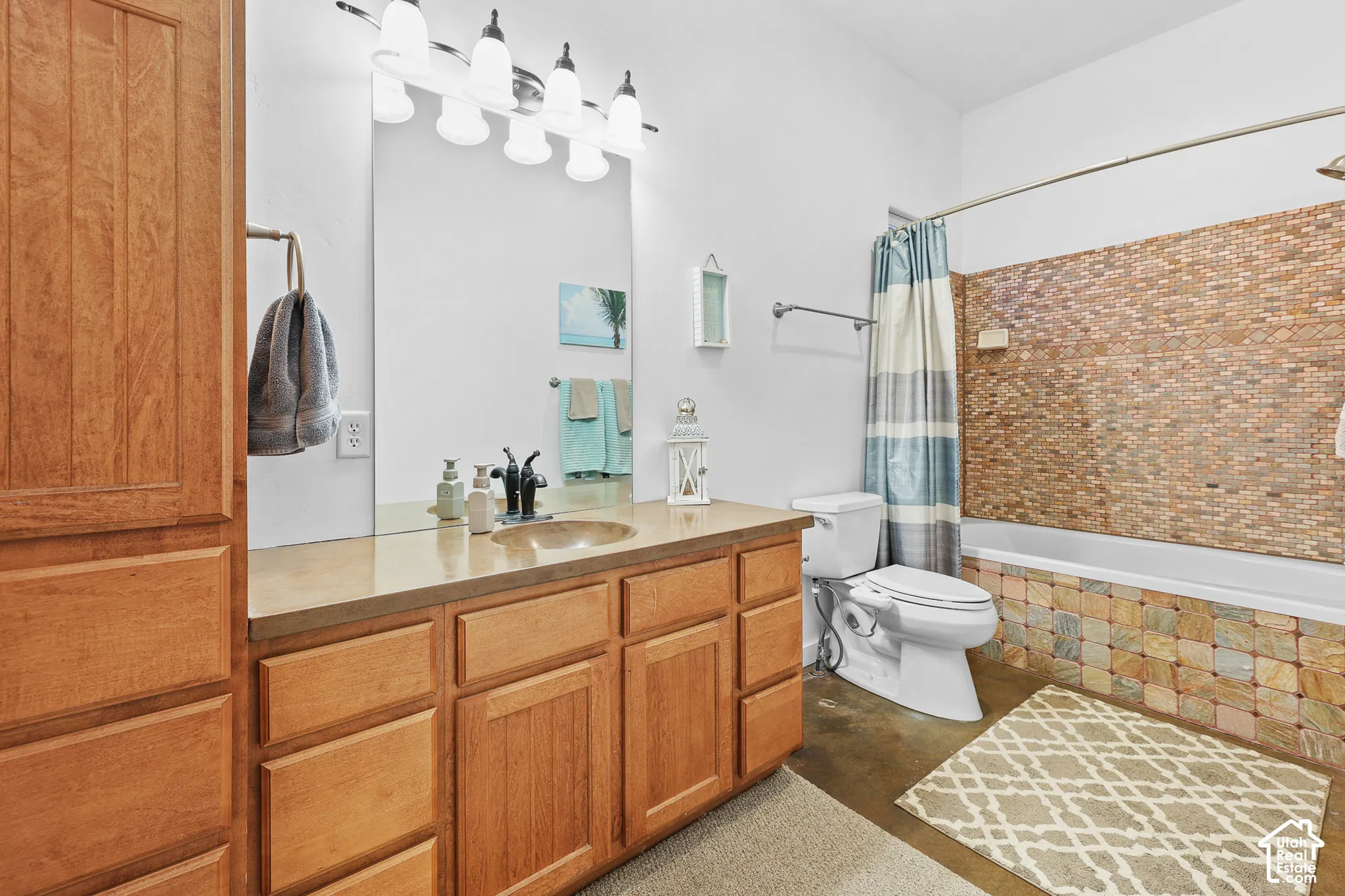 Wood-finish cabinetry with an integrated sink and light-toned countertop