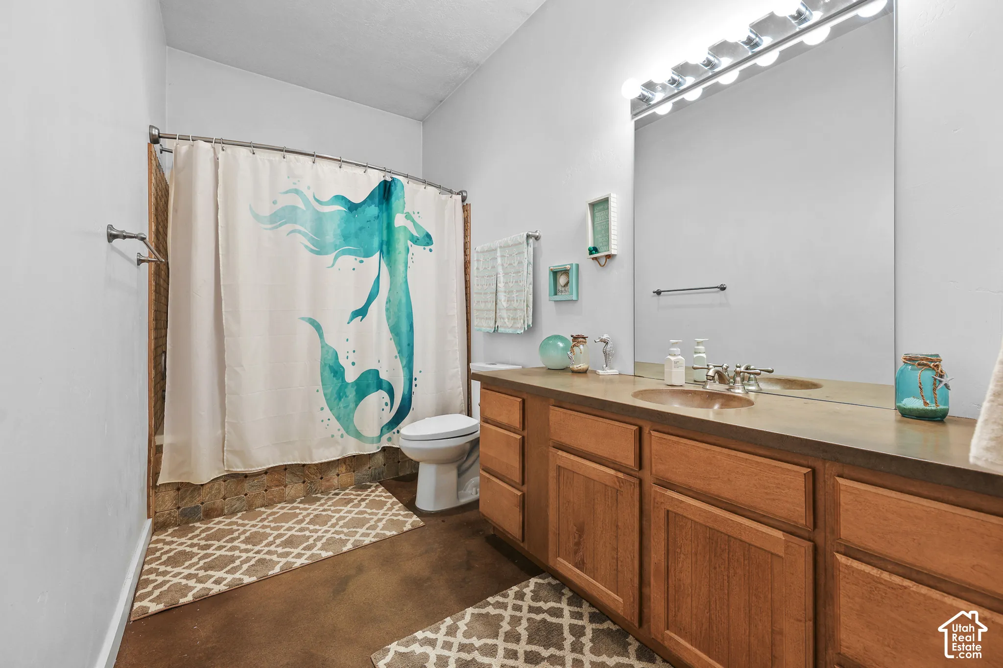 Dual vanity with integrated sinks, ample under-counter storage, and a large wall-mounted mirror