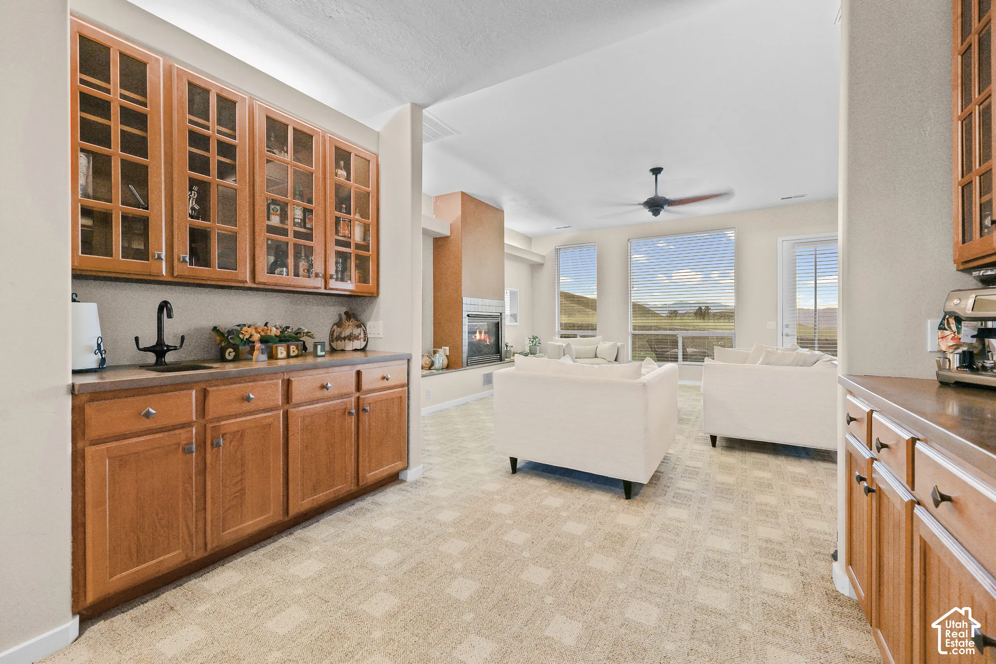 Built-in cabinetry with glass-front uppers and a wet bar