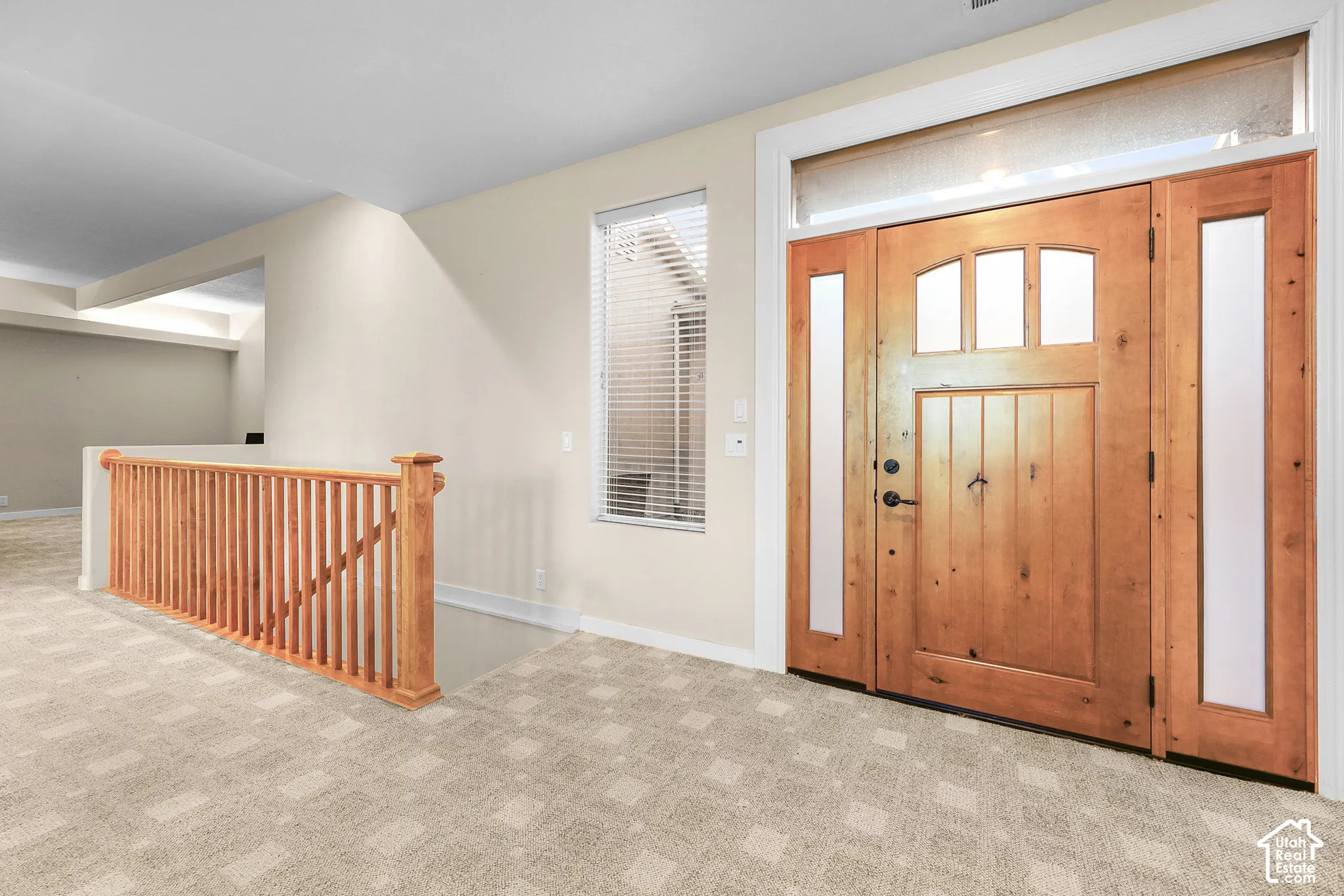 Wood-finish entry door with clear glass sidelights and transom window