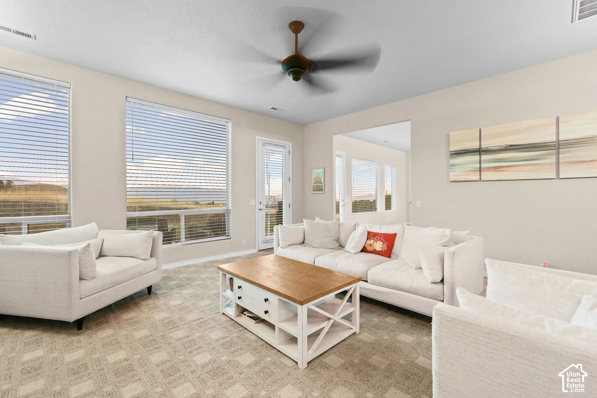 Recessed lighting, ceiling fan, and large windows with blinds