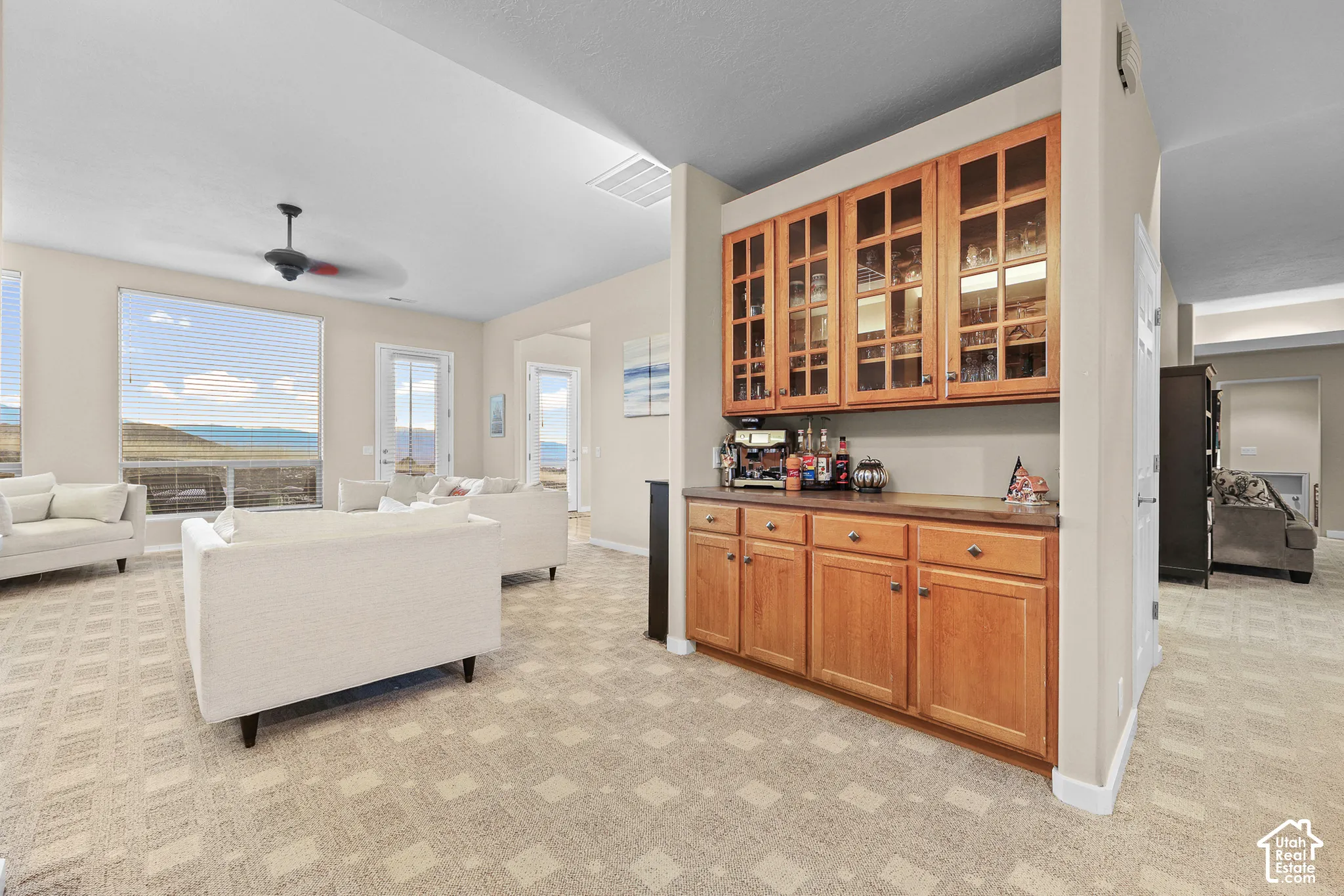 Built-in cabinetry with glass-front upper cabinets and wood-finish base cabinets