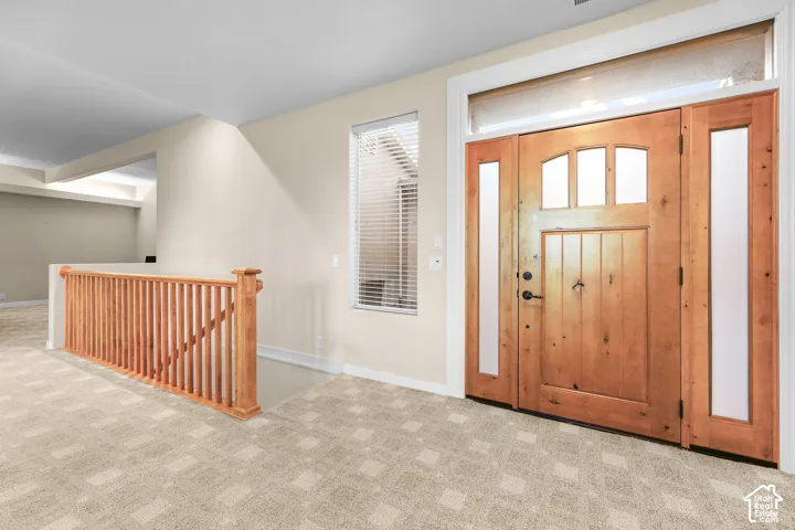 Wood-finish entry door with clear glass sidelights and transom window