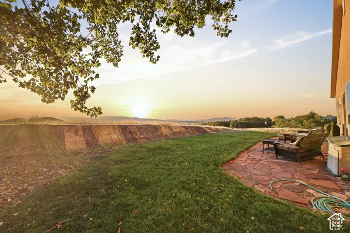 Expansive green lawn with a flagstone patio