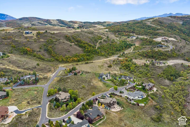 Hillside properties with paved roads and distant mountain ranges