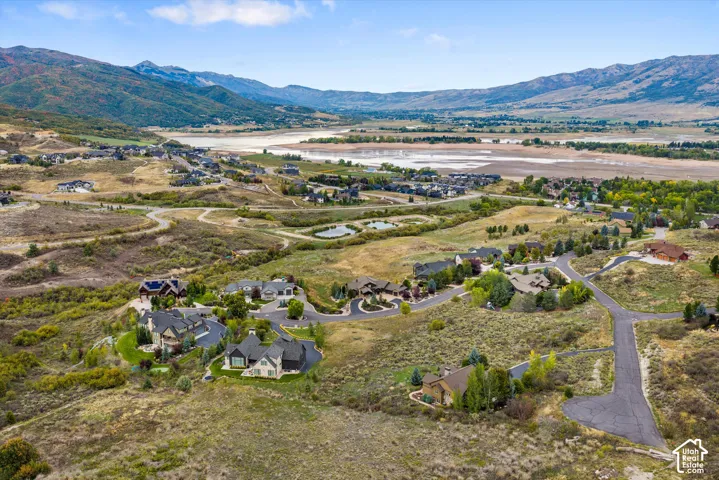 Extensive valley and mountain scenery with residential properties and paved roads