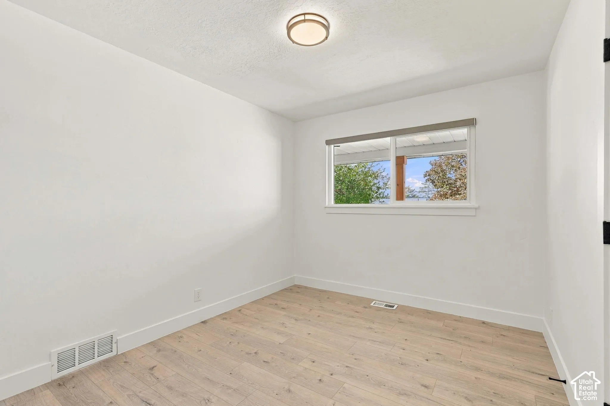 1st bedroom on main floor, lots of natural light with good-sized closet.