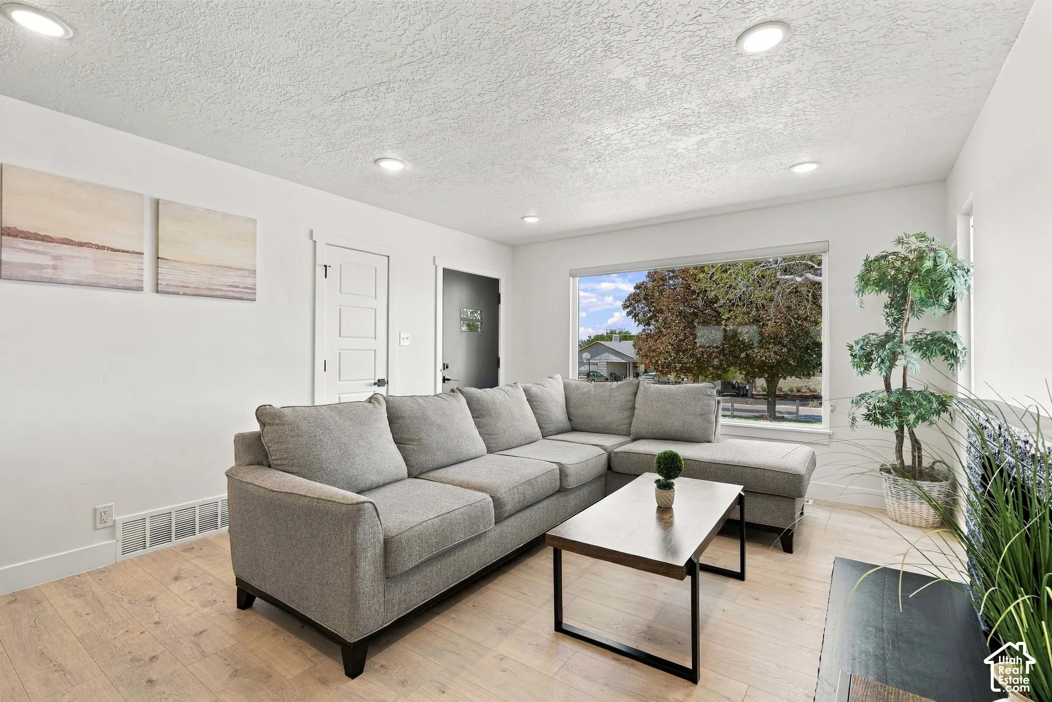 West facing large picture window with recessed lighting