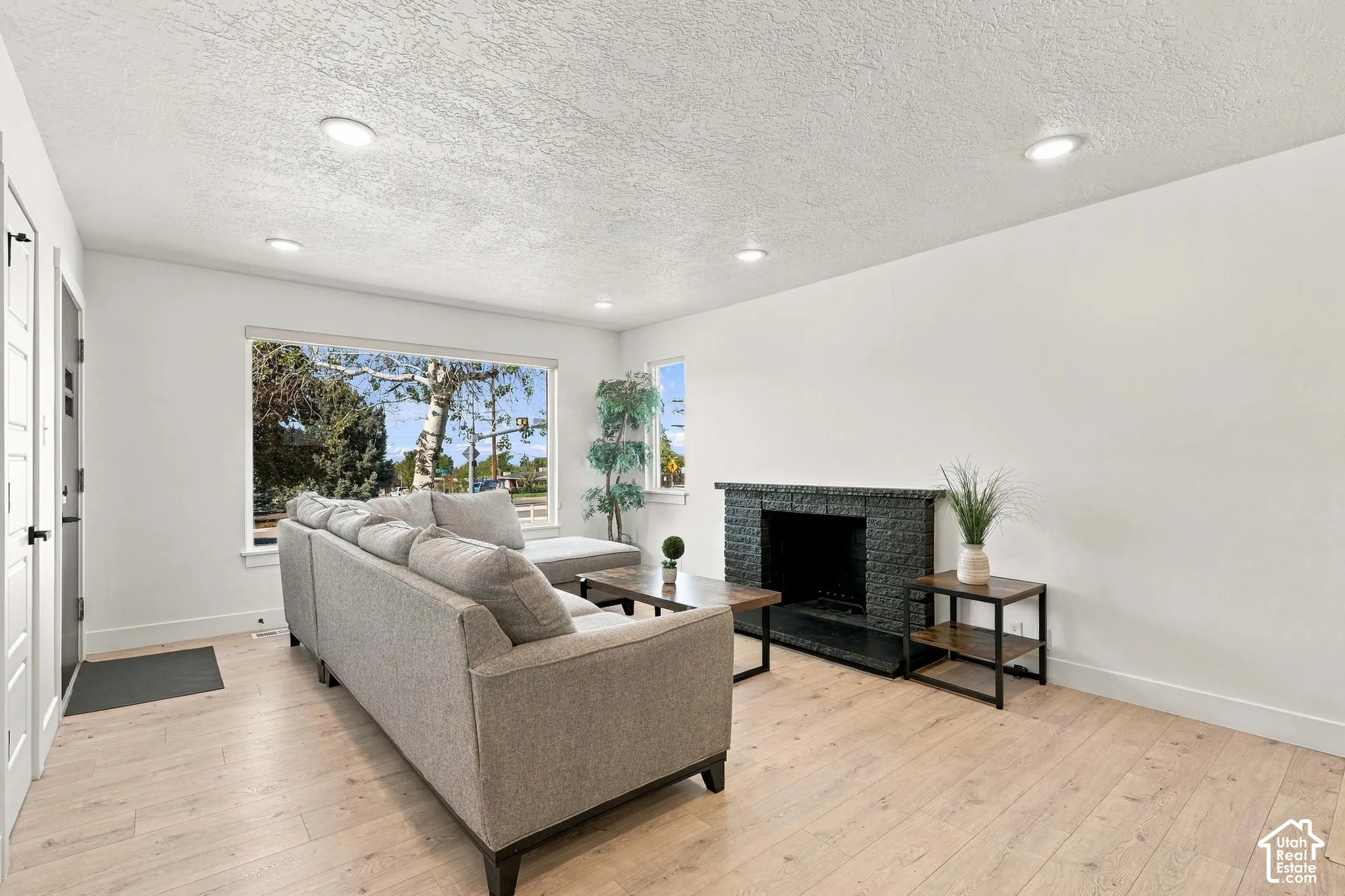 Light luxury vinyl flooring and a dark stone-clad fireplace is the backdrop for movie nights & memories.