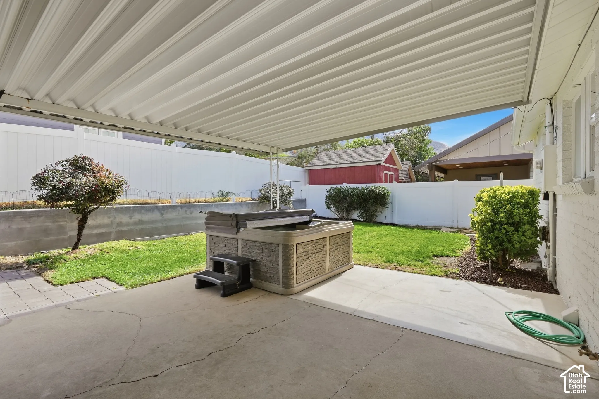 Covered patio featuring a hot tub & a big screen TV for you to relax!!