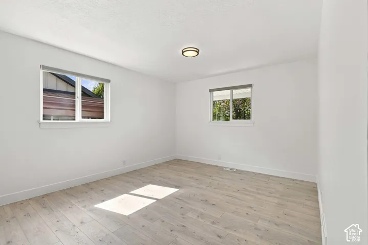 Spacious primary bedroom suite on main floor with windows facing south and west.