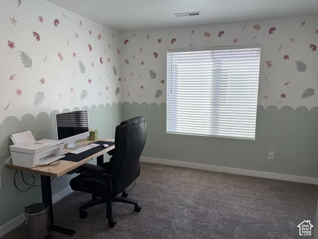 Wall-to-wall carpeting, window with blinds, and white trim