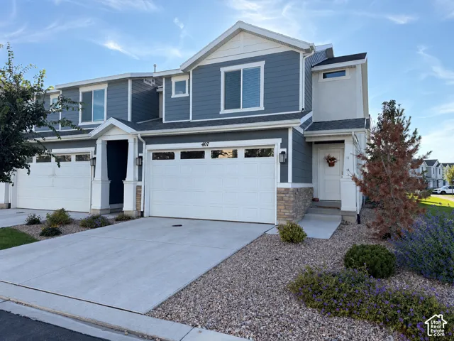 Contemporary exterior with blue siding, white trim, and stone accents