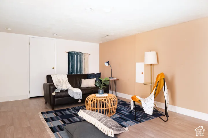 Wood-finish flooring with white trim, recessed ceiling lights, and two-tone wall finishes