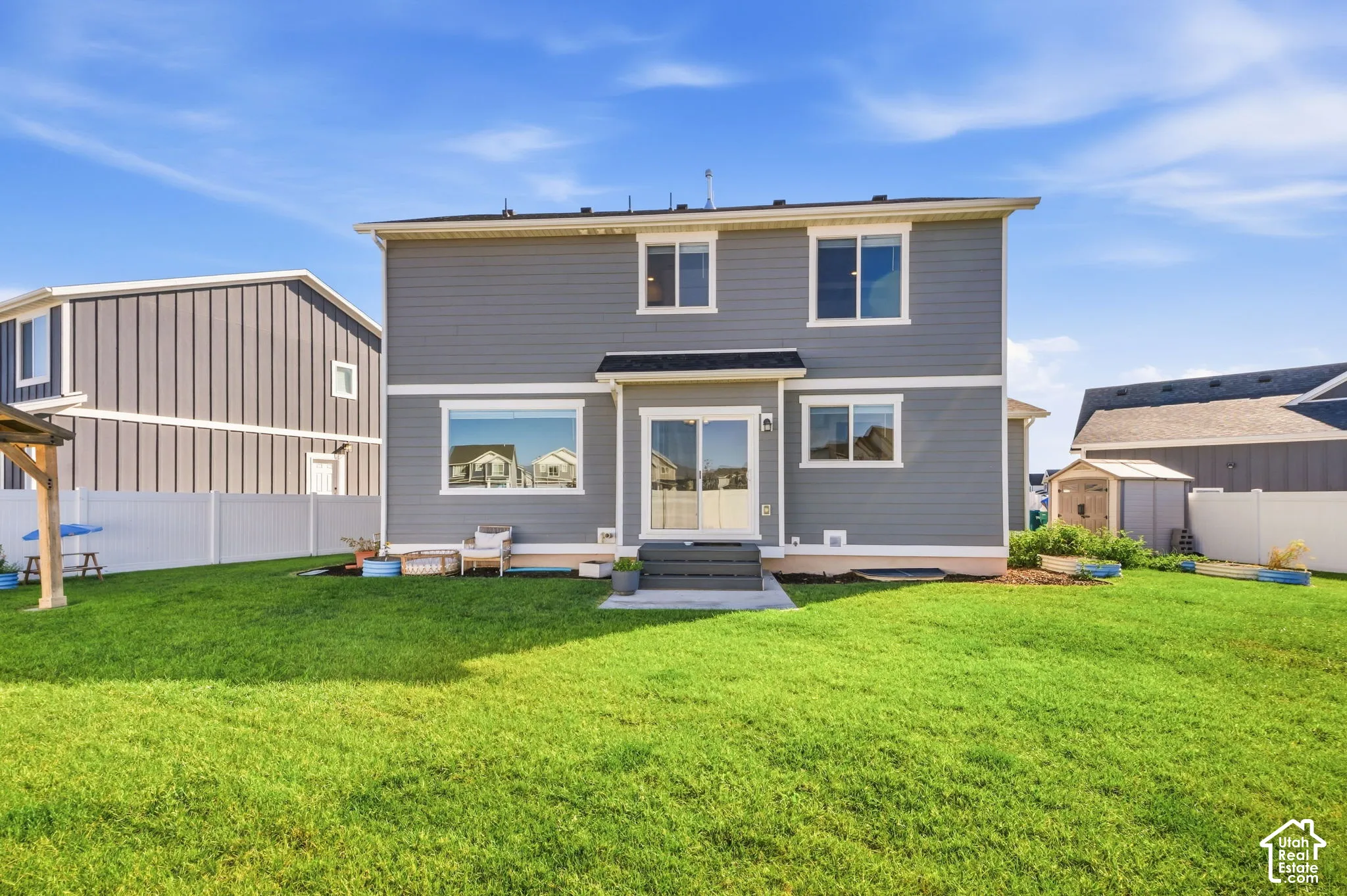 Expansive backyard featuring full vinyl privacy fencing.