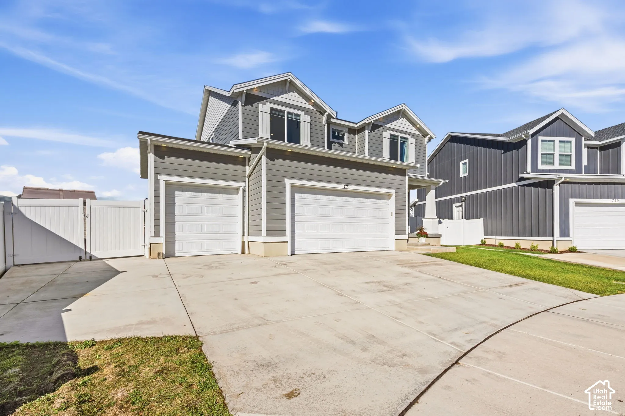 Extra parking on side of 3 car garage with double gate for backyard access.