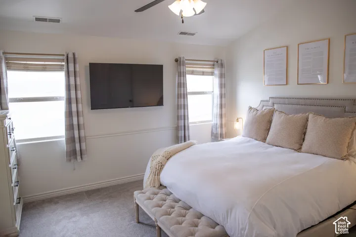 Carpeted flooring, vaulted ceiling, and built-in ceiling fan with light fixture