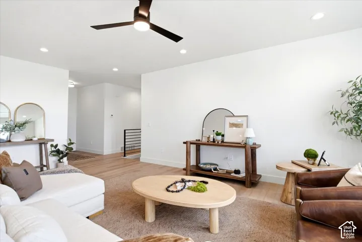 Recessed lighting, wood-finish flooring, and a modern ceiling fan with integrated lighting