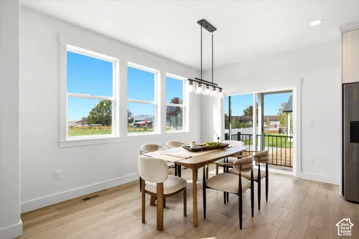 Light wood-finish flooring with white baseboards
