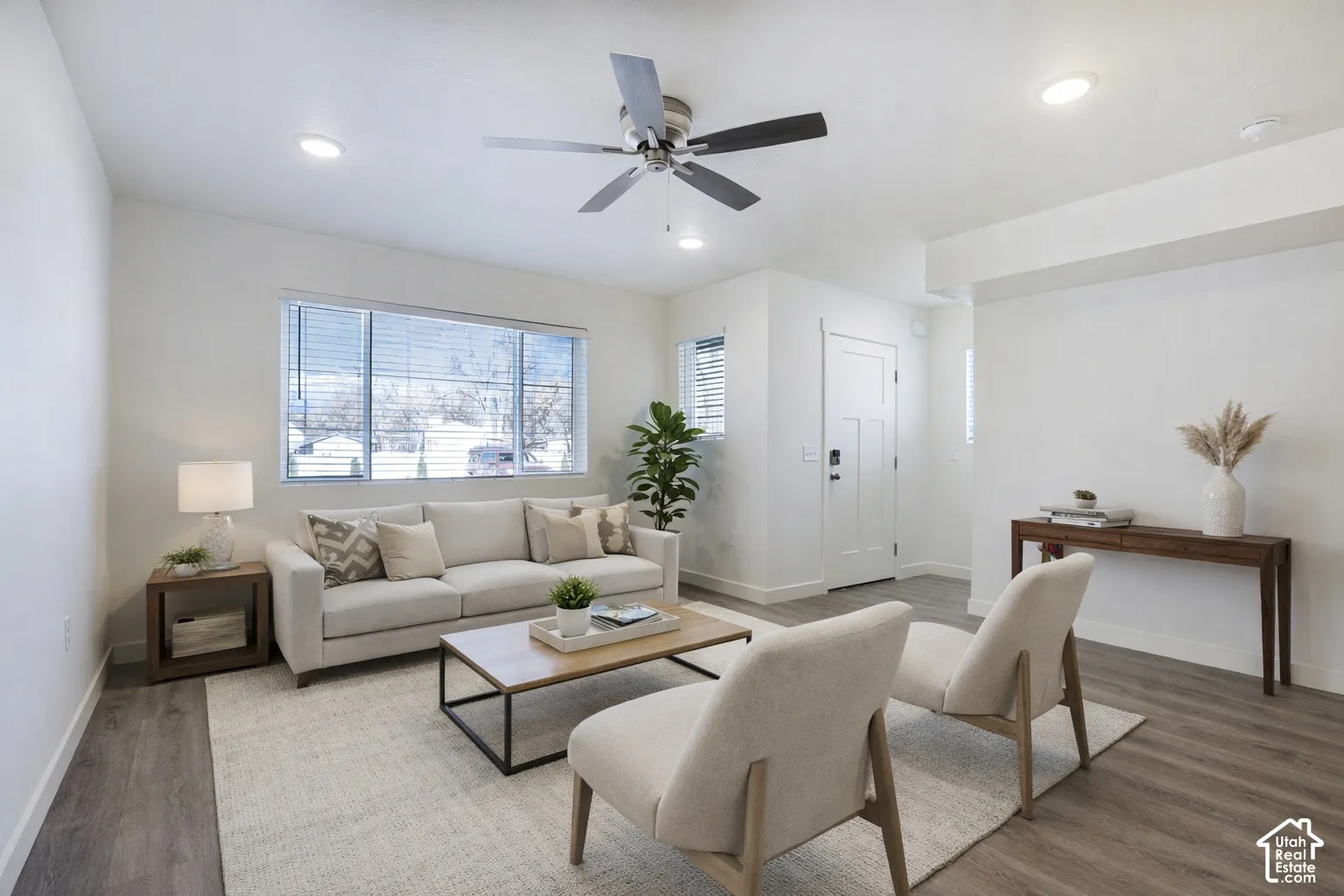 Open-concept living space featuring recessed lighting, a modern ceiling fan, and wood-finish flooring