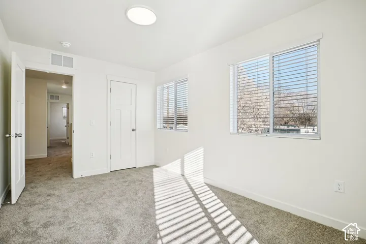 Neutral wall paint and plush carpet flooring