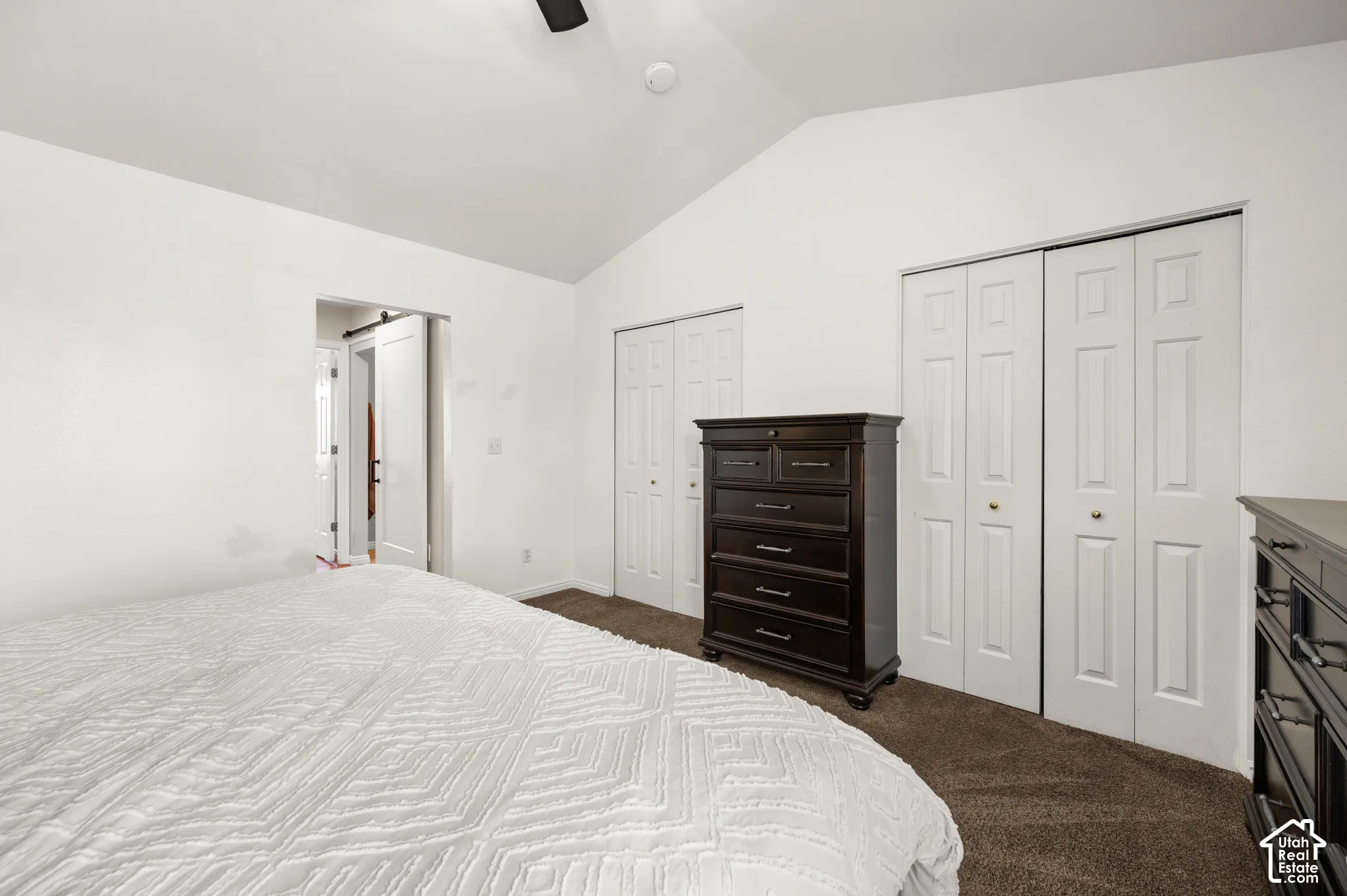Vaulted white ceiling with a ceiling fan