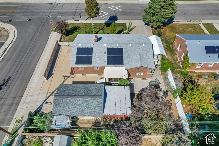 Brick exterior with a shingle roof and solar panels