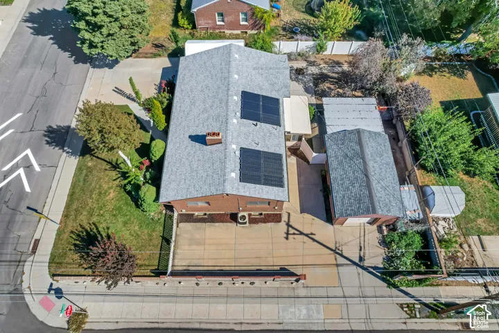 Roofline with installed solar panels, brick exterior, and a detached garage