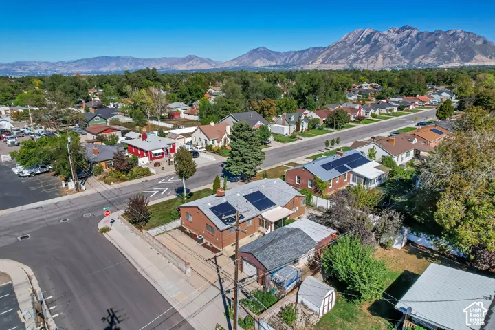 Residential neighborhood with mature trees and mountain scenery