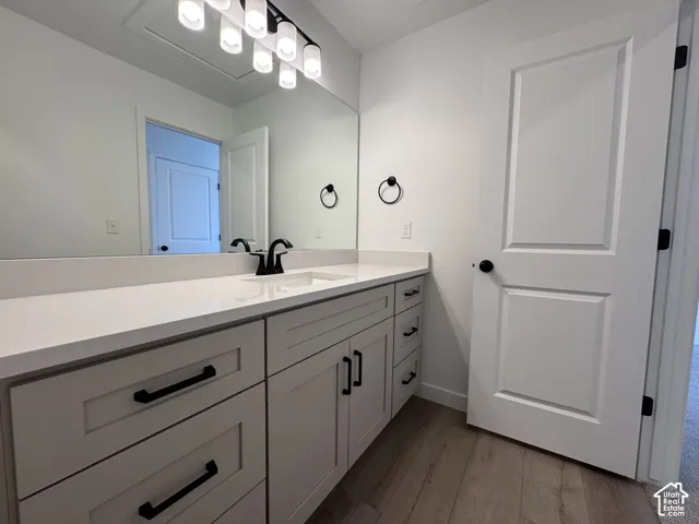 Extended vanity with an integrated sink, light-toned countertop, and matte black fixtures