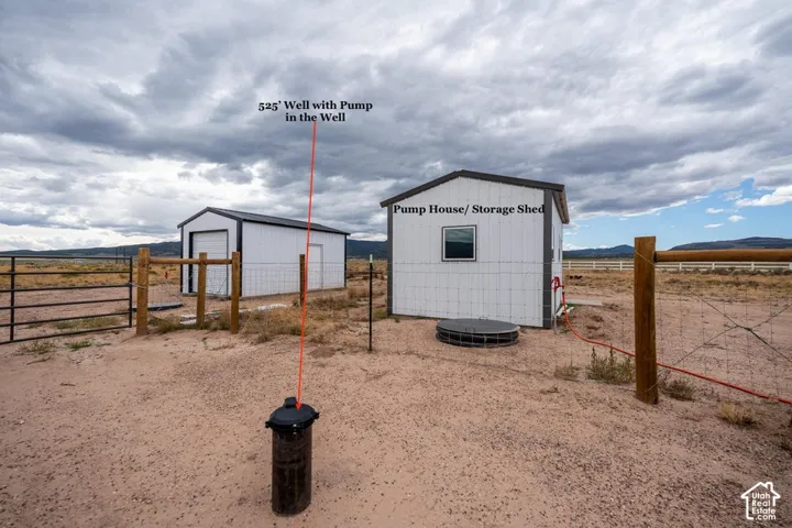 Pump house/storage shed with a single window, a 525' well with pump, and perimeter fencing