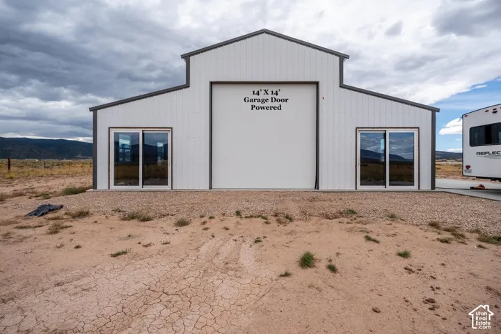 Metal construction with a white finish, featuring a 14' x 14' powered garage door