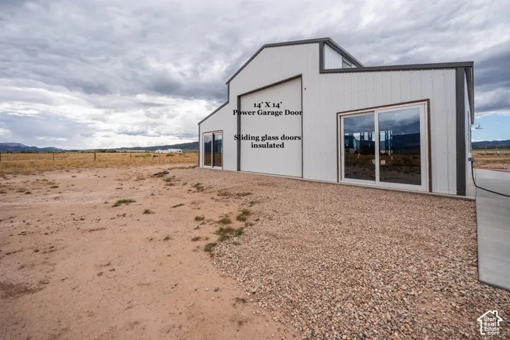 White metal siding exterior with a dark trim roofline