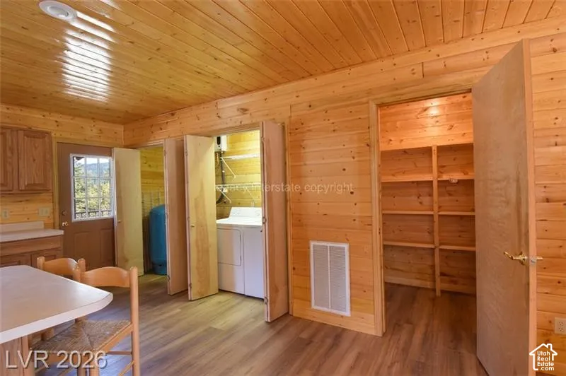 Wood-finish flooring, paneled wood walls, and wood-paneled ceiling