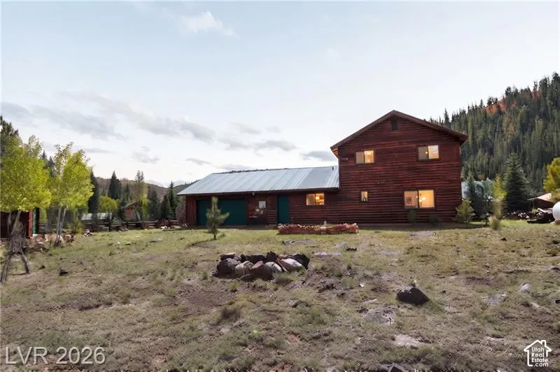 Wood-sided residence with multiple windows and a metal roof