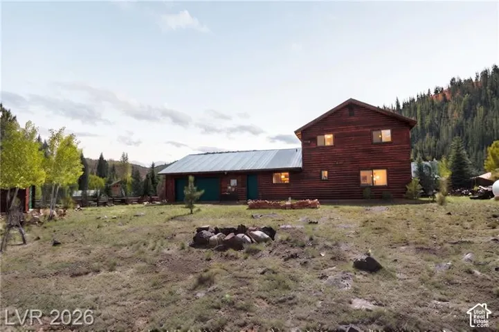 Wood-sided residence with multiple windows and a metal roof