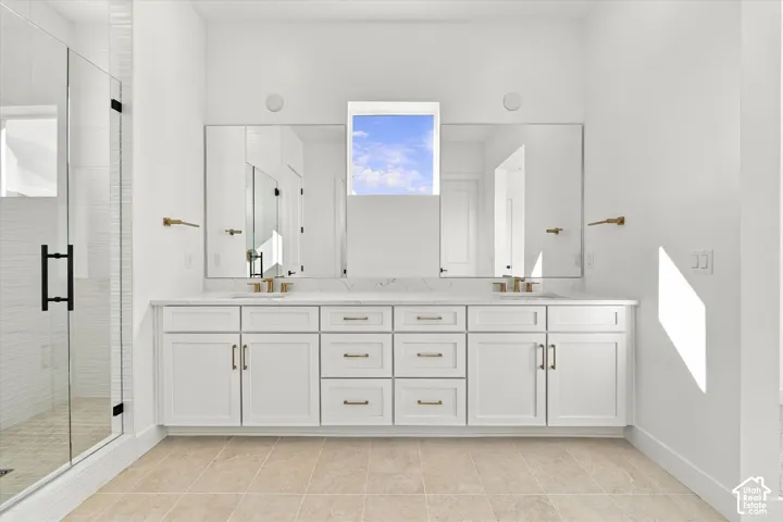 Dual vanity with white cabinetry and gold-tone hardware