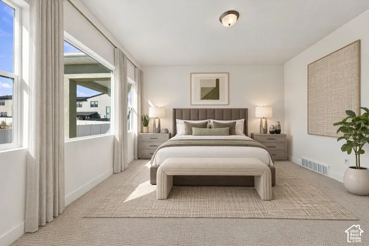 Neutral-toned wall-to-wall carpeting, expansive windows, and a flush-mount ceiling light fixture