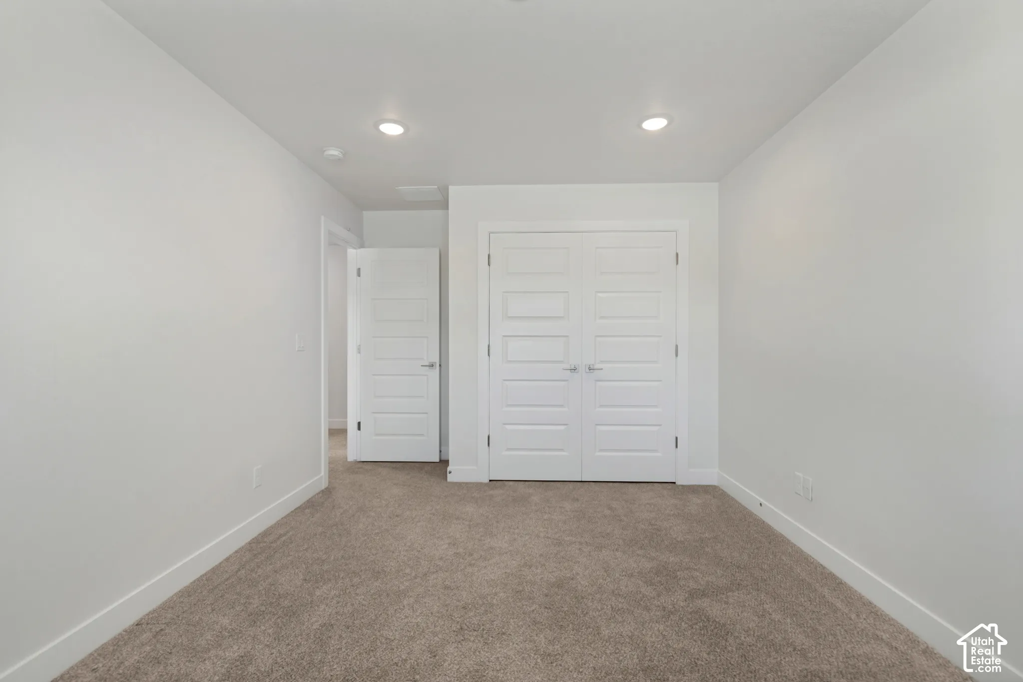 Neutral-toned carpeting with white walls and trim