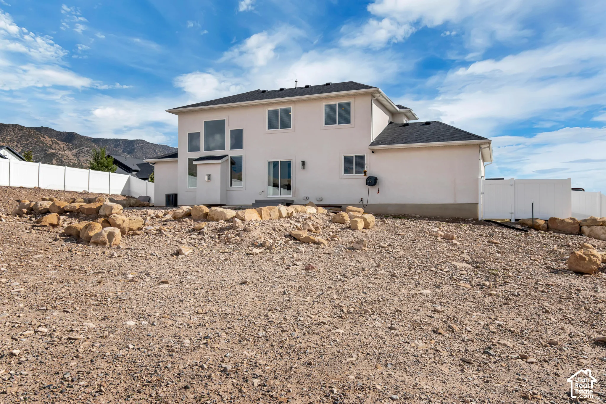 White stucco exterior with black shingle roof