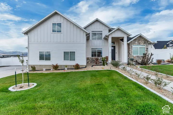 Contemporary exterior featuring board-and-batten siding and stone accents