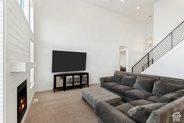 Vaulted ceilings and a fireplace with a decorative mantel enhance the living area