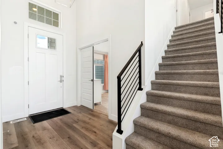 Entryway featuring wood-finish flooring and a white paneled door with transom window