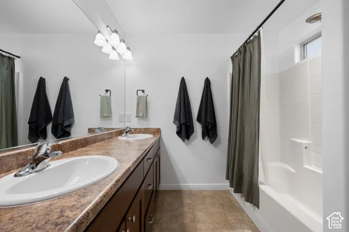 Double vanity with integrated sinks, chrome fixtures, and a spacious countertop
